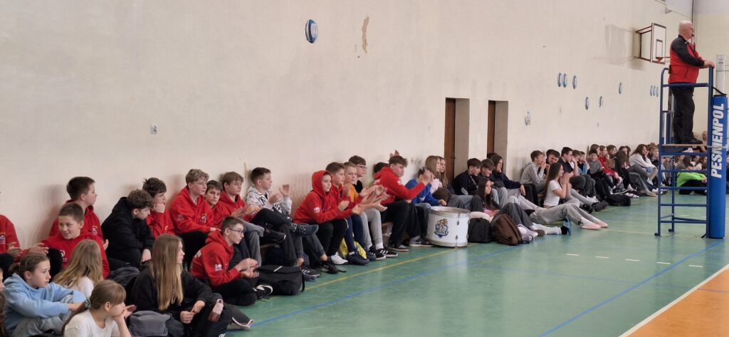 Kibice szkoły podczas meczu dopingujący siatkarzy.